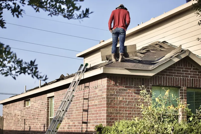 Professional roofer working on a residential roof in Country Place